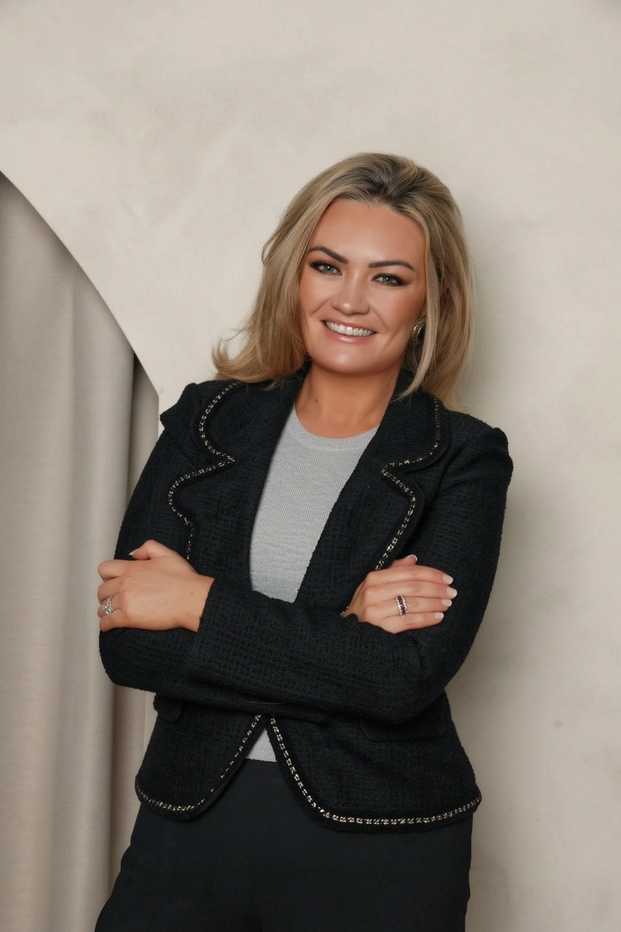Dannielle Haig, Business Psychologist, in a tweed jacket with arms crossed